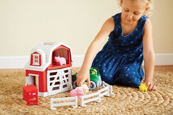 A girl playing with farm playsets